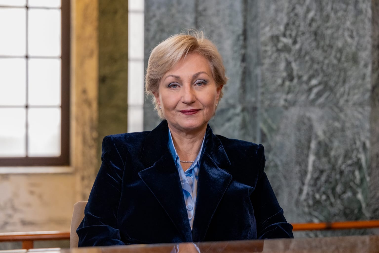 Donna bionda con occhiali che lavora al computer